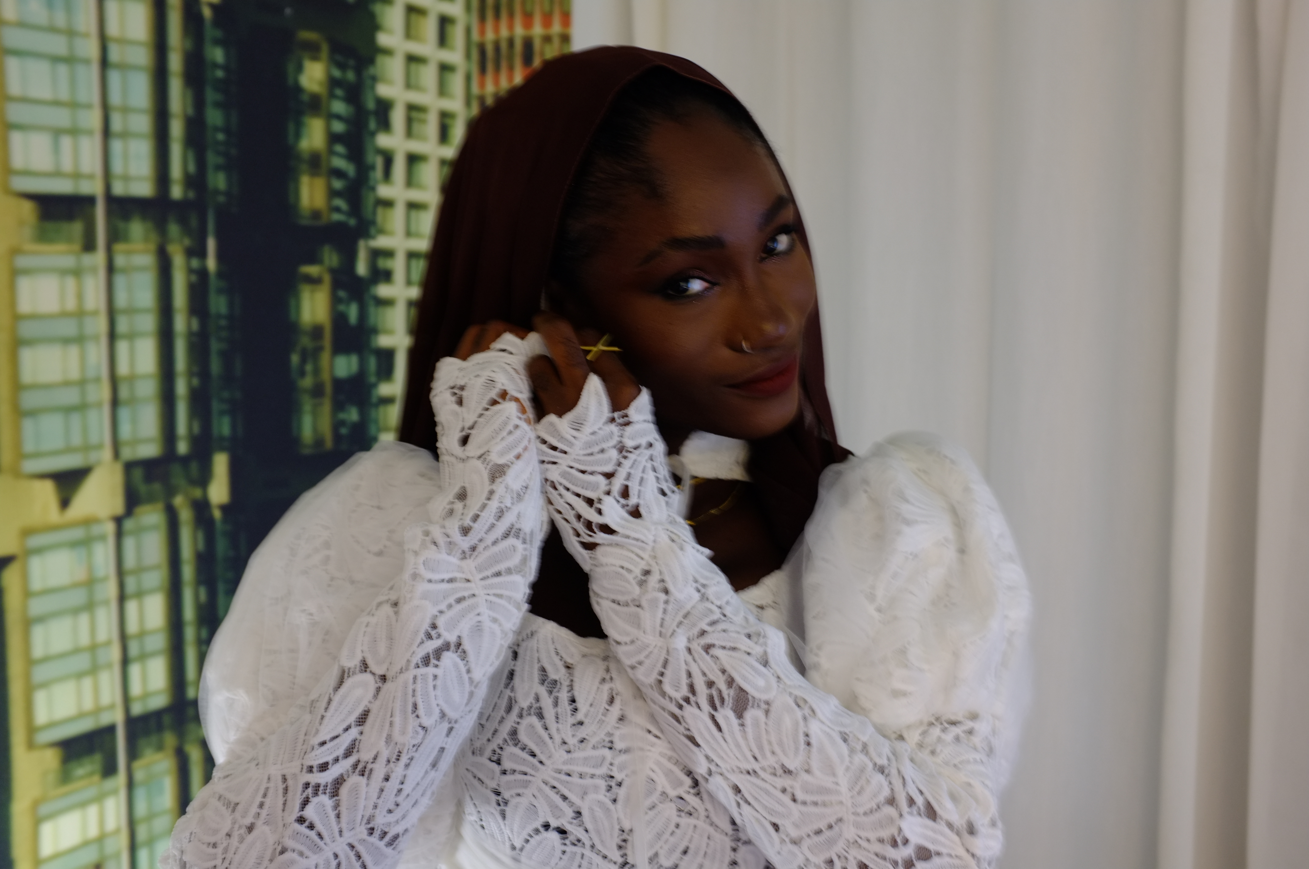 Hauwa Lawal in a close portrait, wearing a white lace dress